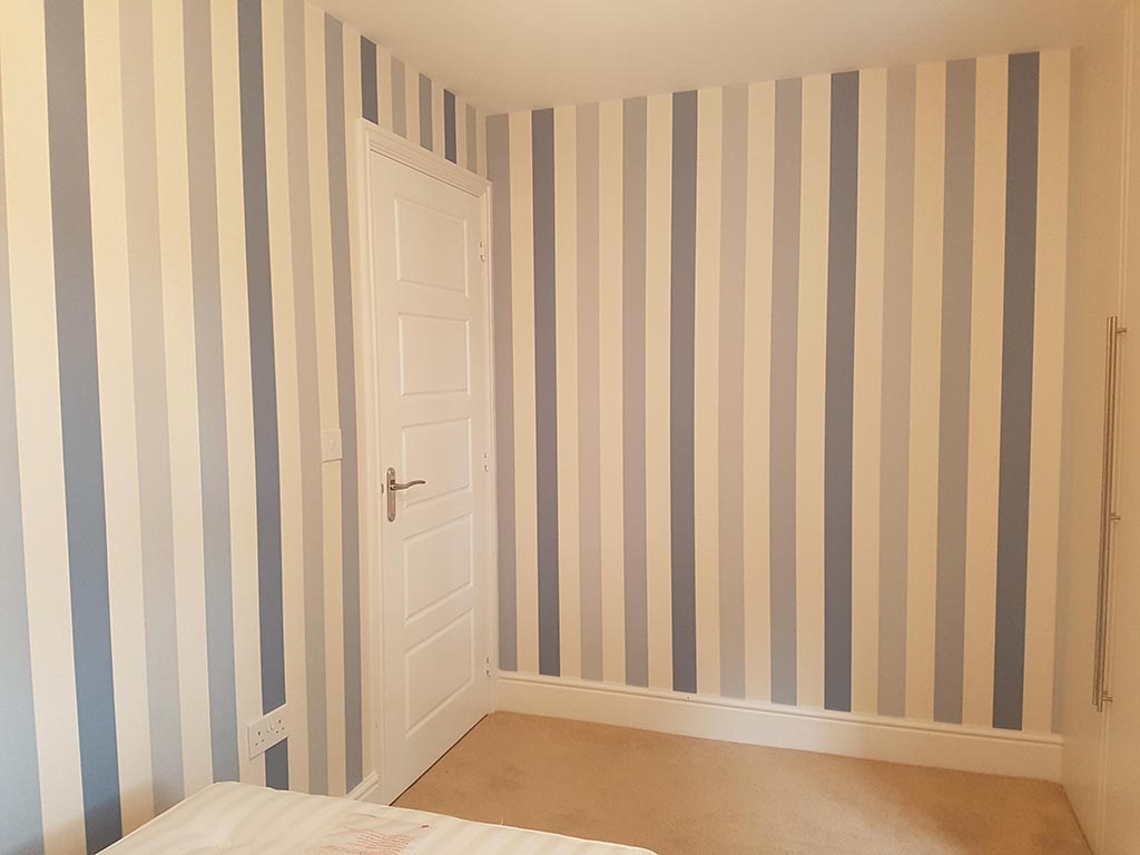 Bedroom in solihull with blue striped wallpaper