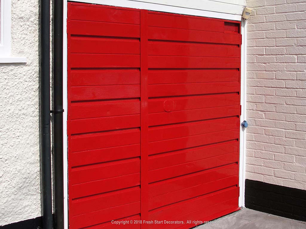 garage doors being painted by fresh start decorators