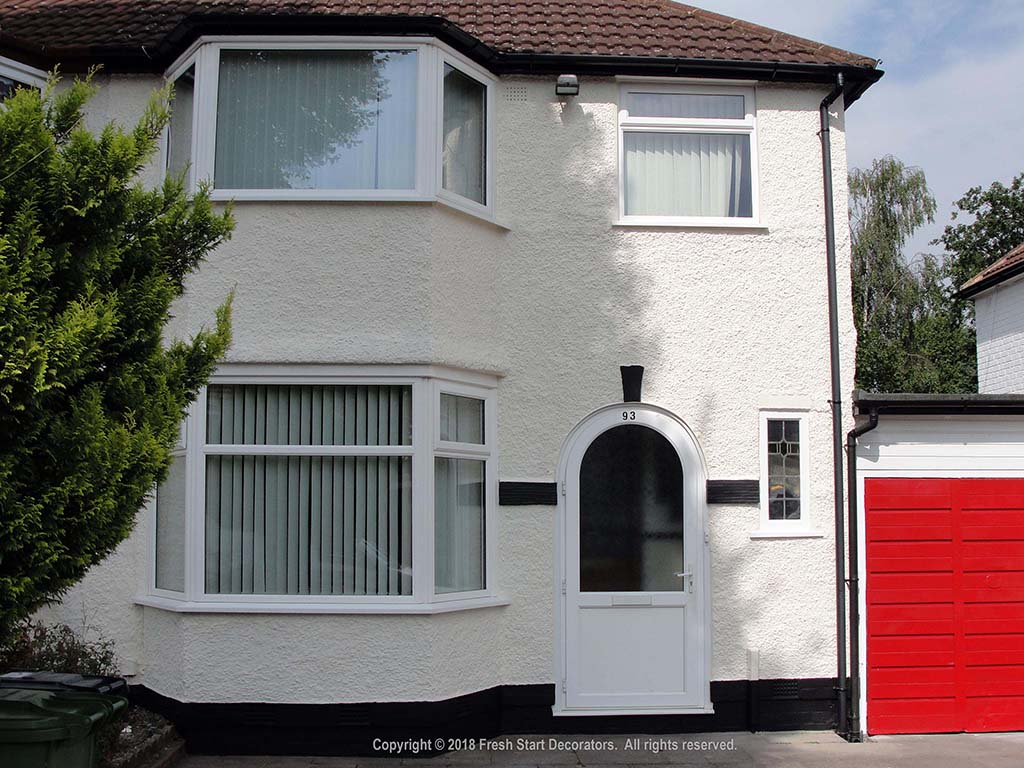 Domestic home exterior being painted by decorator