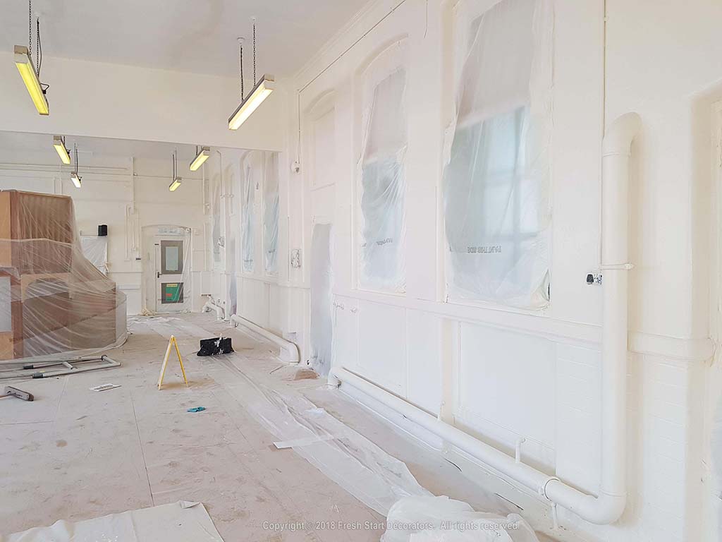 Sheeting and spray painting interior walls