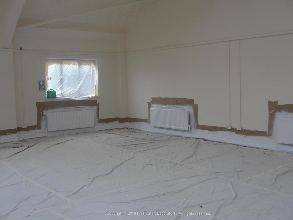 interior painters use paint spraying in hall