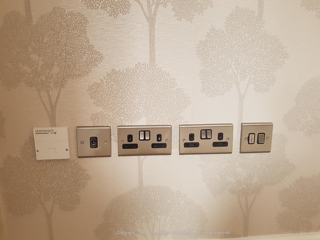 wallpaper applied around switches